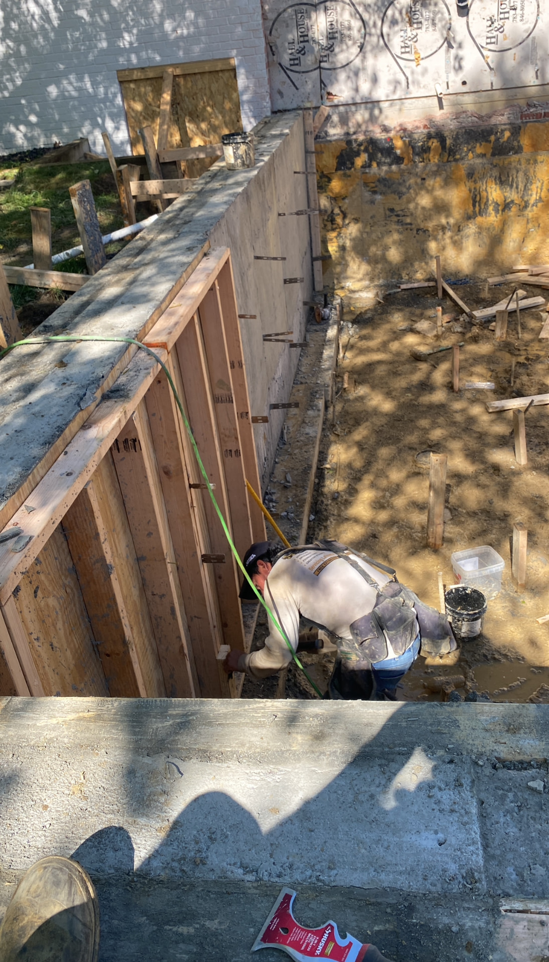 Crew finishing a tall foundation wall form