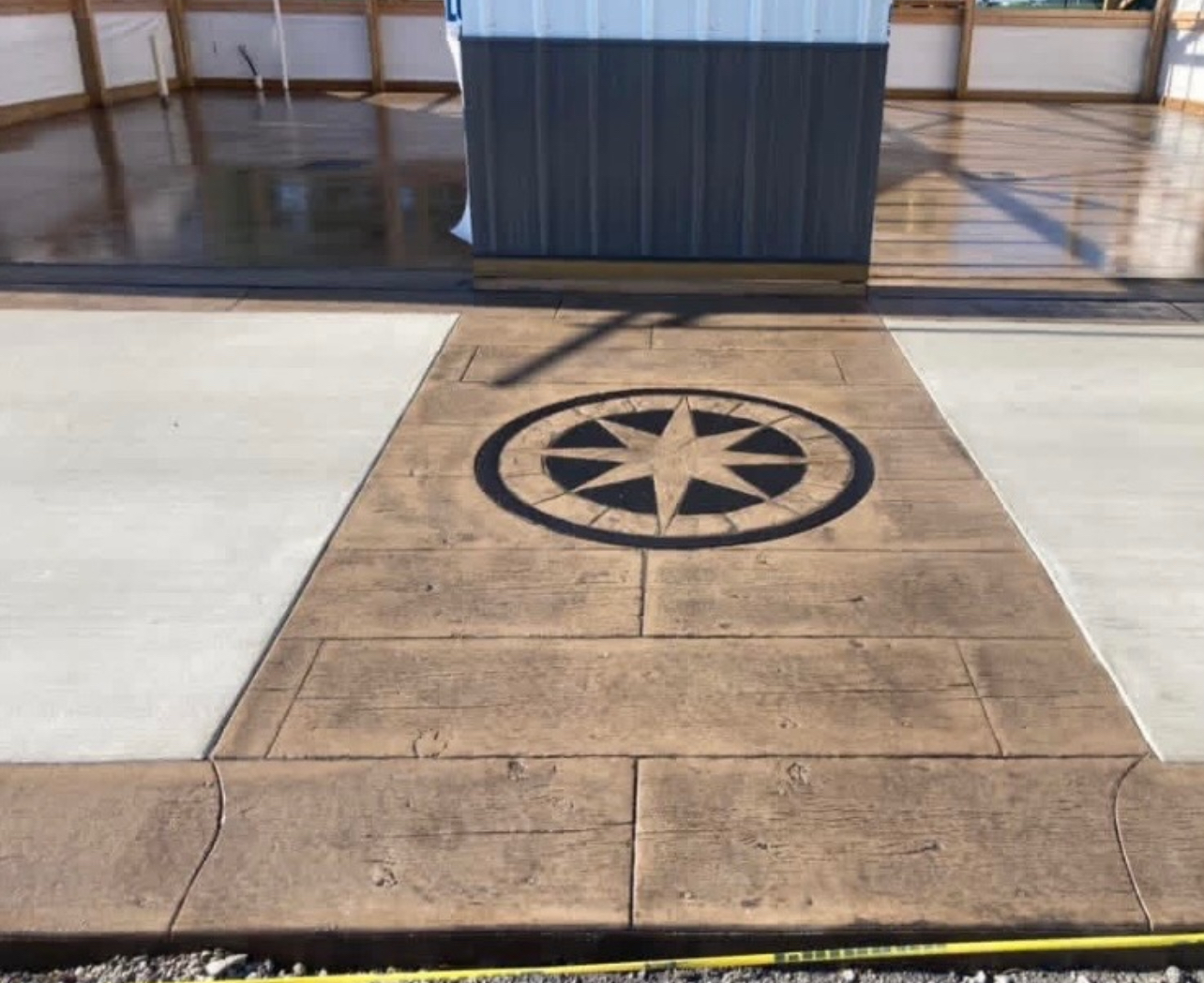 Stamped concrete walkway with compass design